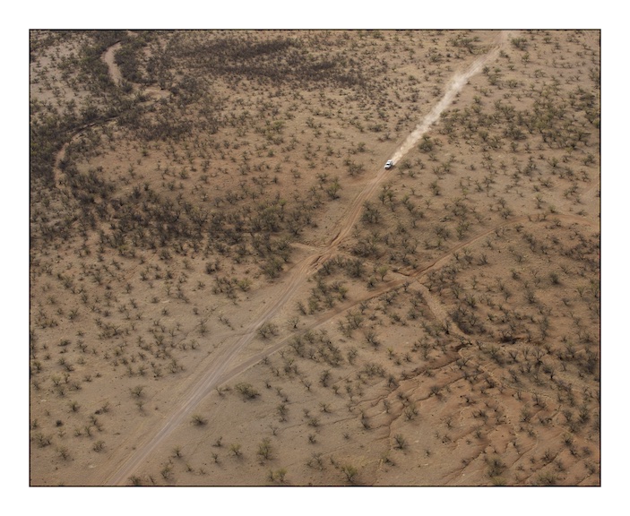  A solitary United States Border Patrol vehicle on patrol in the Coyote Mountains Wilderness, Southern Arizona. Migrants will normally travel in dried river beds like the one seen running from top left to bottom right of this photograph. River beds have shade and offer some cover.&nbsp; 