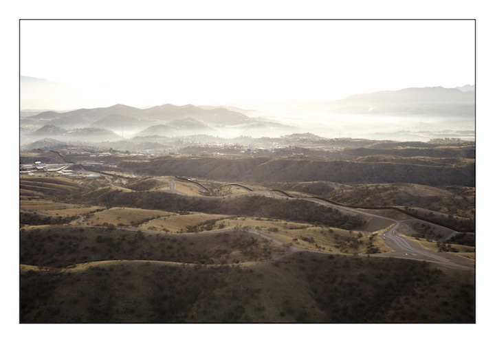  The border fence between Mexico (above) and the United States (below) snakes it’s way through the once prosperous town of Nogales which straddles the border. Nogales was a town where Americans and Mexicans would visit frequently to trade goods and engage in commerce. Now businesses struggle and the value of real estate has dropped forcing many American families to live elsewhere. 