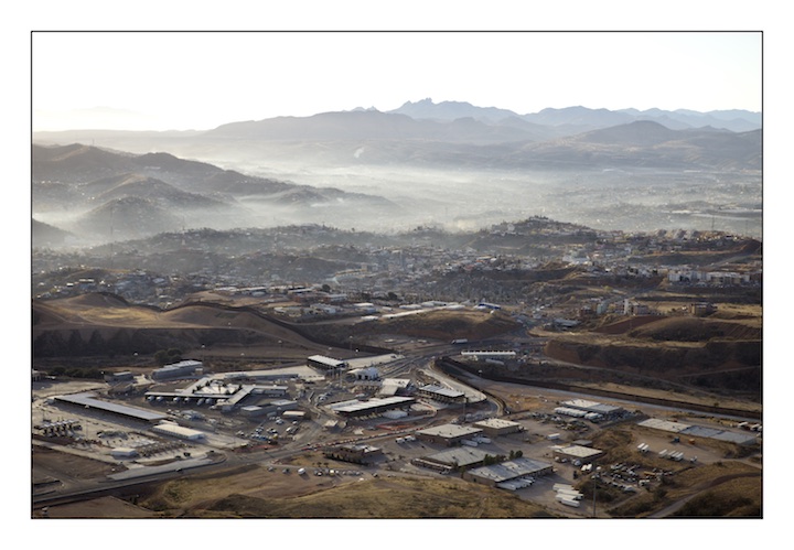  The border fence between Mexico (above) and the United States (below) snakes it’s way through the once prosperous town of Nogales which straddles the border. Nogales was a town where Americans and Mexicans would visit frequently to trade goods and engage in commerce. Now businesses struggle and the value of real estate has dropped forcing many American families to live elsewhere. 