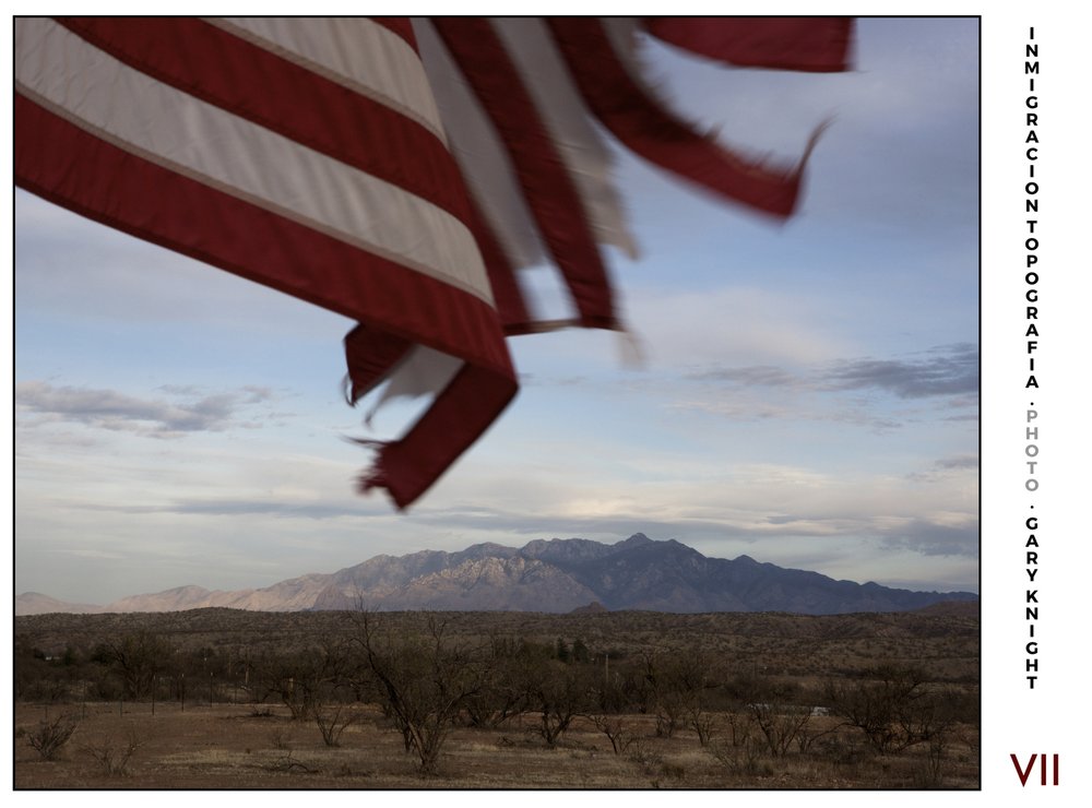  A US flag tethered to a family gatepost flutters in the afternoon breeze on the road between Arivaca and Amado, in the background is the Santa Clara mountain range. 